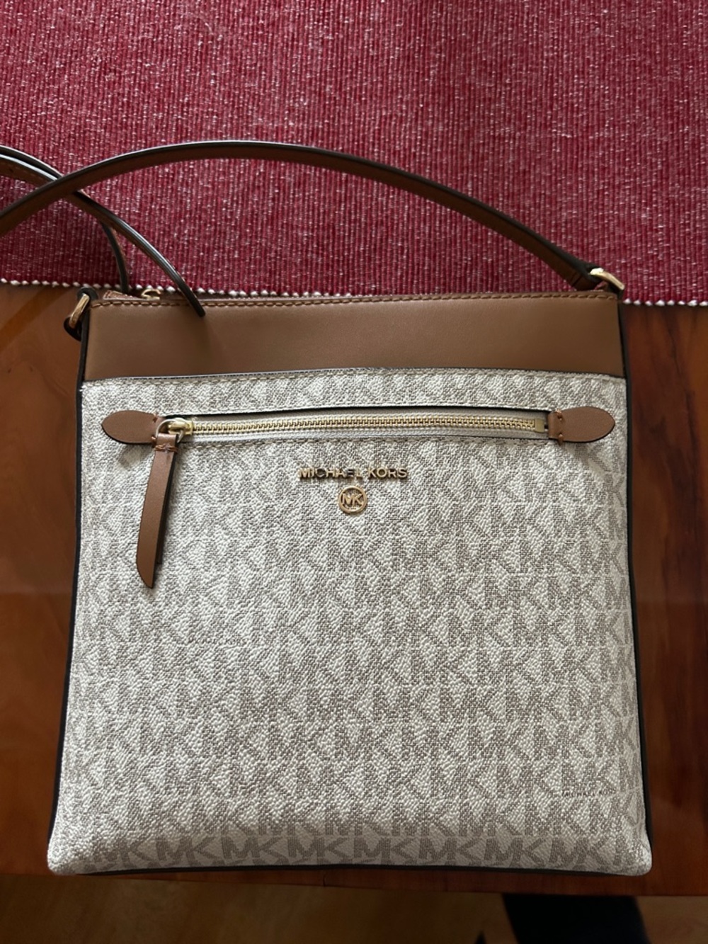 Zipper charm is missing and there are some ink stains from a pen (pictured)